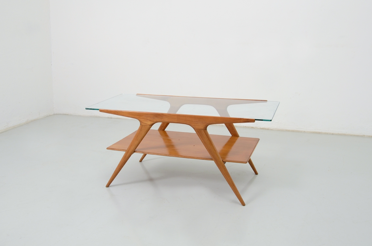 Elegant 1950's coffee table in cherry wood with very nice thin tips and a crystal glass top.