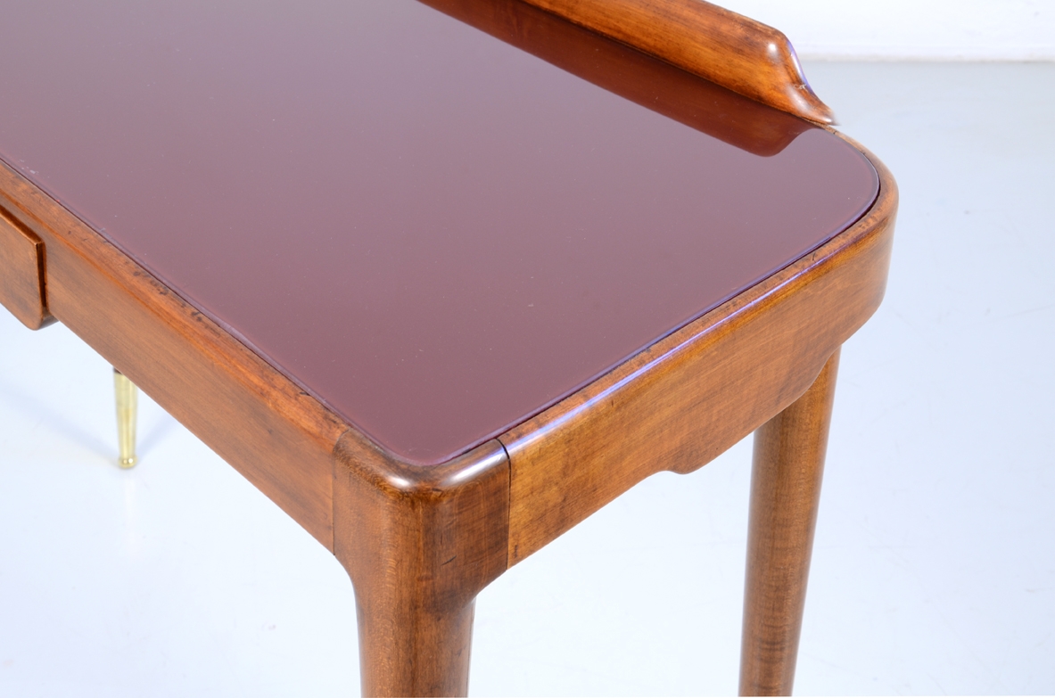 Elegant Italian 1950's console table with thin legs on long bronze tips.