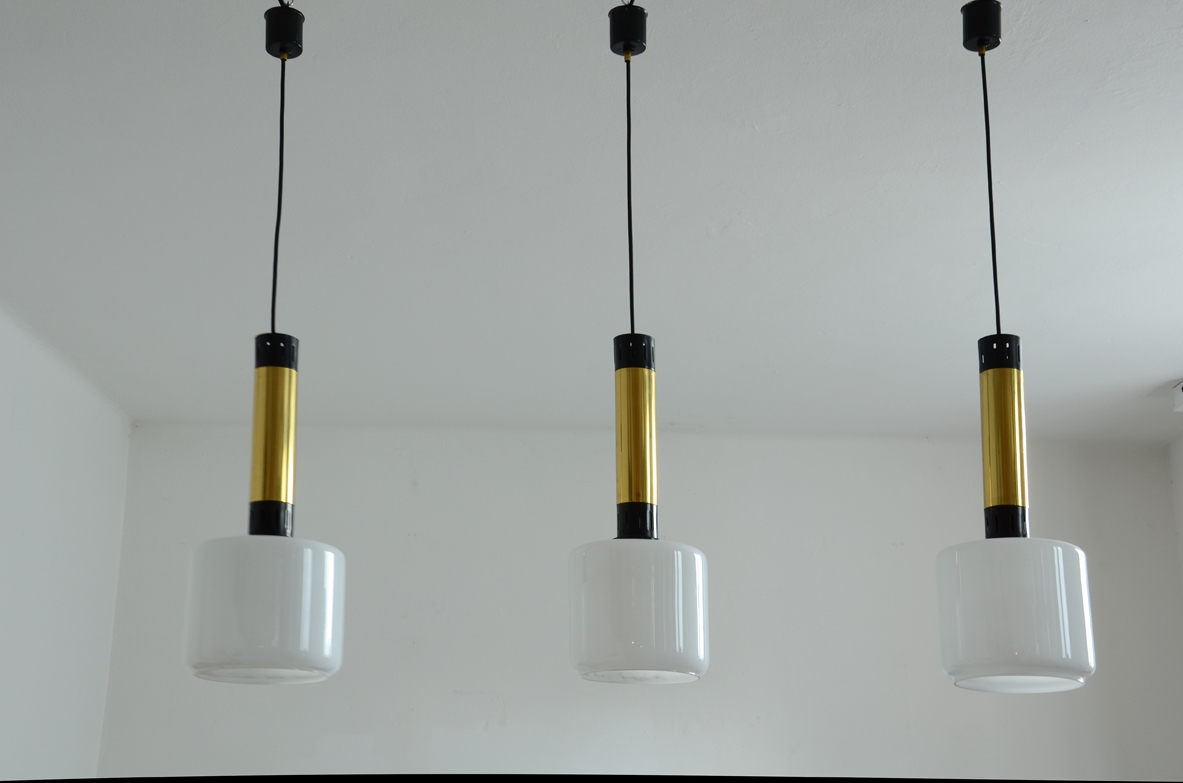 Three elegant 1960’s Stilnovo ceiling lamps in brass and polished metal with a nice and big opal glass shade.  Prod. Stilnovo, Milano.