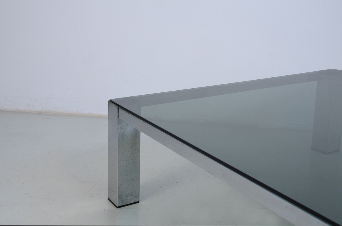Large coffee table with metal structure and square glass top. 1960ca.