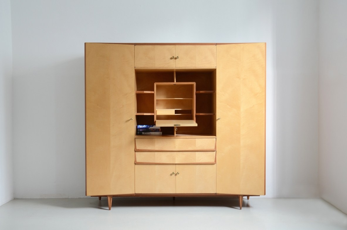 Unique Italian 1960's highboard in light maplewood. Doors and drawers with shelves inside and a very special central open compartment with a folding top hiding small shelves and one drawer.
