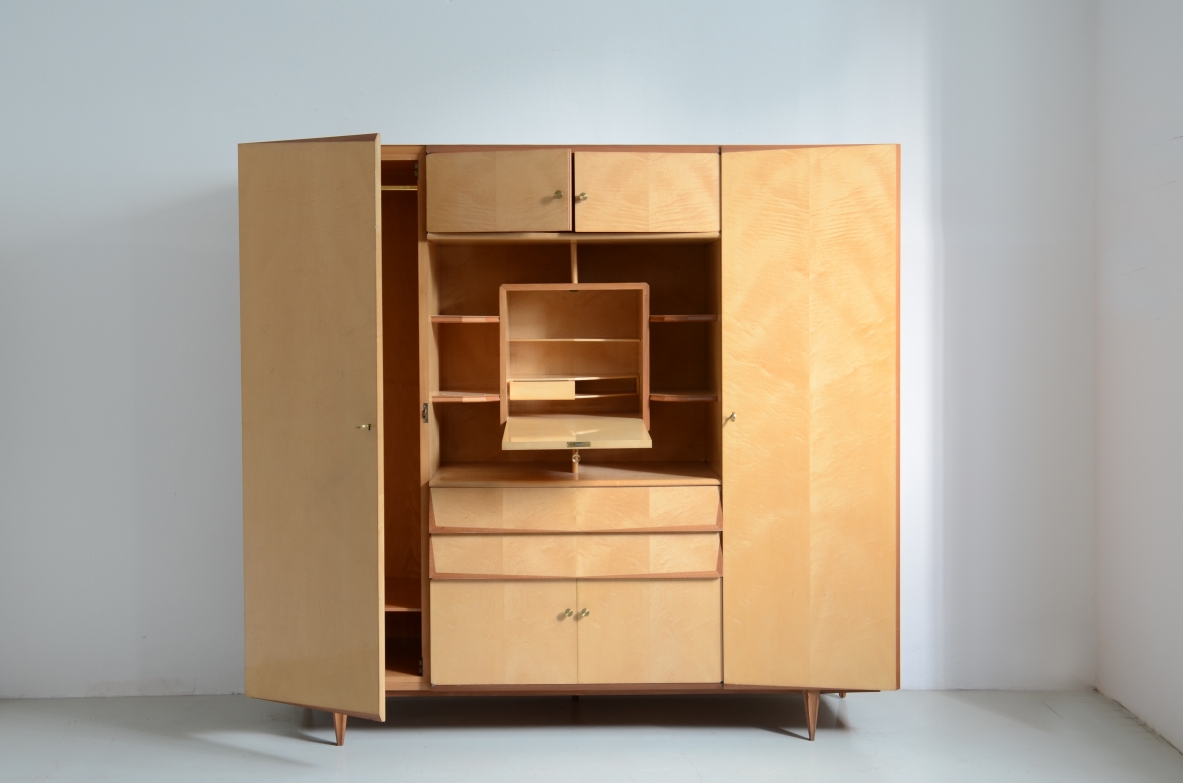 Unique Italian 1960's highboard in light maplewood. Doors and drawers with shelves inside and a very special central open compartment with a folding top hiding small shelves and one drawer.
