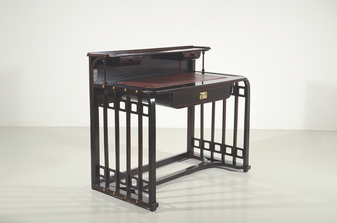 Josef Hoffman, rare writing desk designed in 1905 ca. and manufactured by J.& J. Khon, Vienna. Beech stained to simulate mahogany, top with a dark red leather, brass handle and details. Lit.: Kohn factory catalogue, 1906, p. 58.
