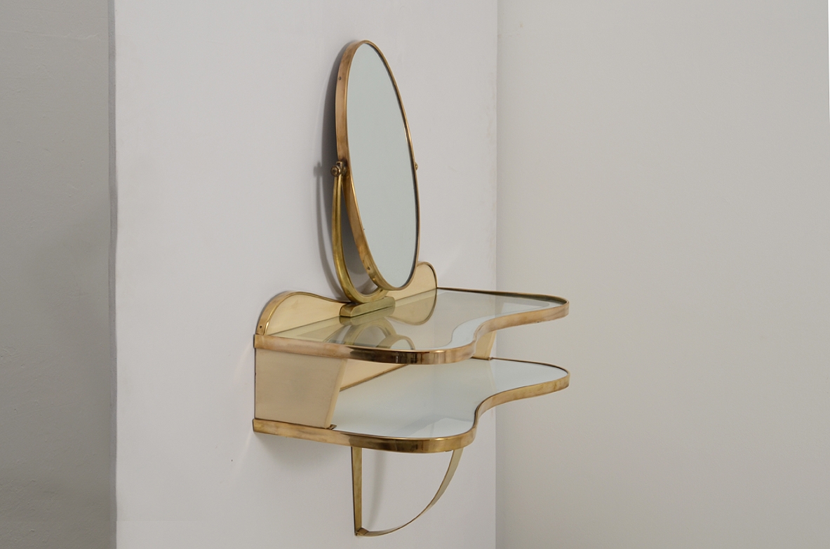 Gio Ponti, rare hanging console table in lacquered wood and brass with two shelves, one in mirrored glass and one in white opaline. Adjustable oval mirror on top. Provenience Cellina/Bormioli private collection. Gio Ponti Archive ref. Nr 16089.