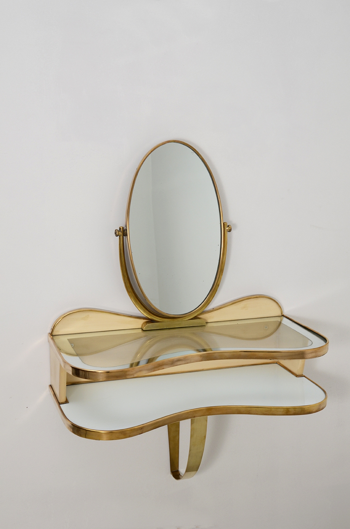Gio Ponti, rare hanging console table in lacquered wood and brass with two shelves, one in mirrored glass and one in white opaline. Adjustable oval mirror on top. Provenience Cellina/Bormioli private collection. Gio Ponti Archive ref. Nr 16089.