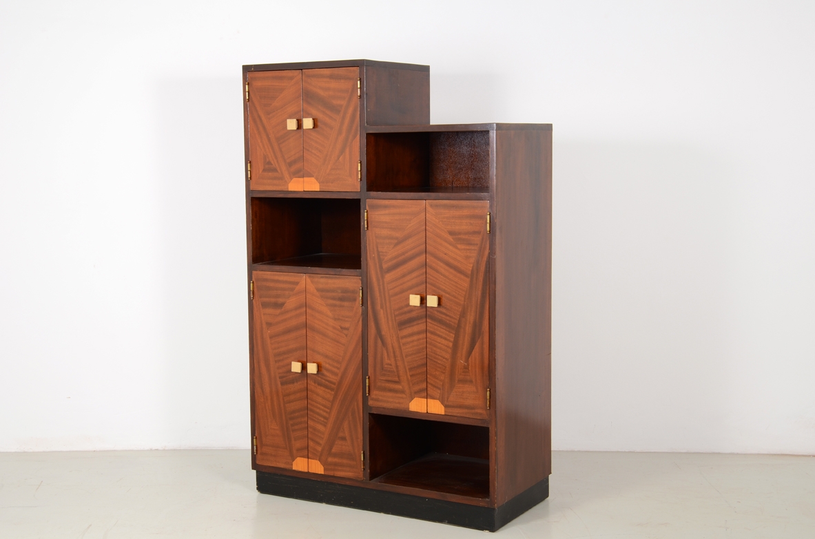 Italian 1930's cabinet with nice inlaid wood on his front doors and carved handles in bown. Rare example belonging to the 