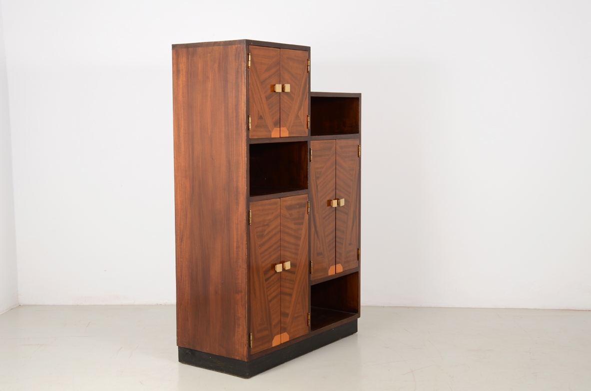Italian 1930's cabinet with nice inlaid wood on his front doors and carved handles in bown. Rare example belonging to the 