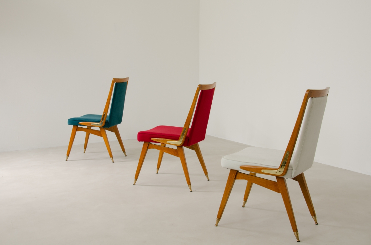 Set of 8 beautiful 1950's Italian chiars in light oak wood with refined brass tips and details. Upholstery on seat and back.