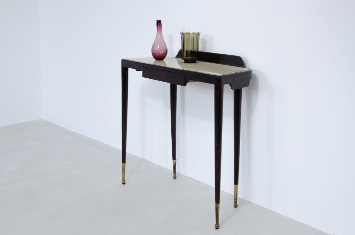 Elegant Console table with thin legs in stained wood and long brass tips. Central drawer and top in ivory opaline glass.  1950's Italian manufacture.