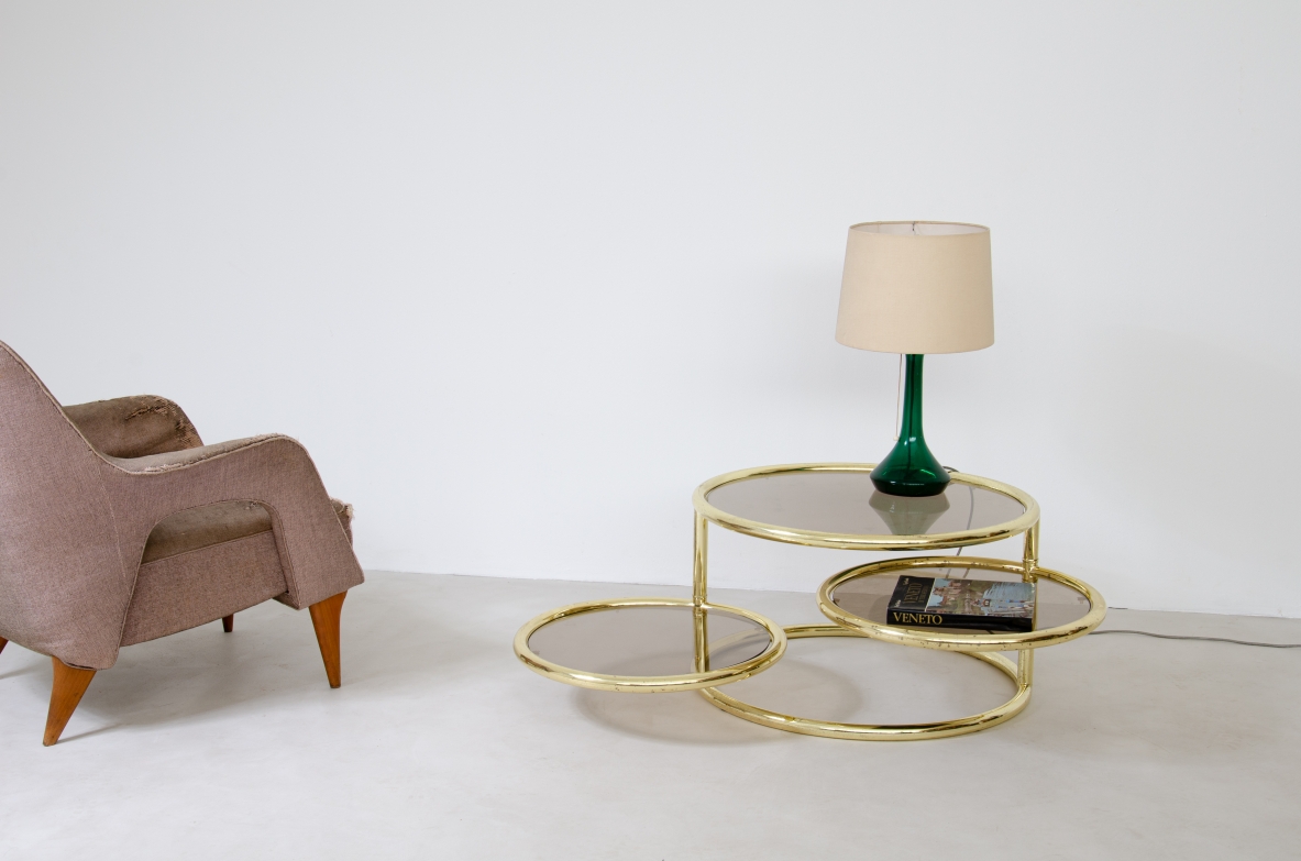 Coffee table in brass with rotating elements and original glass top. Italy 1970's.