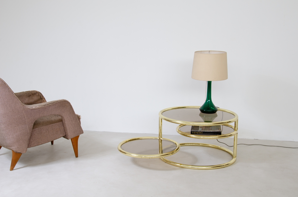 Coffee table in brass with rotating elements and original glass top. Italy 1970's.