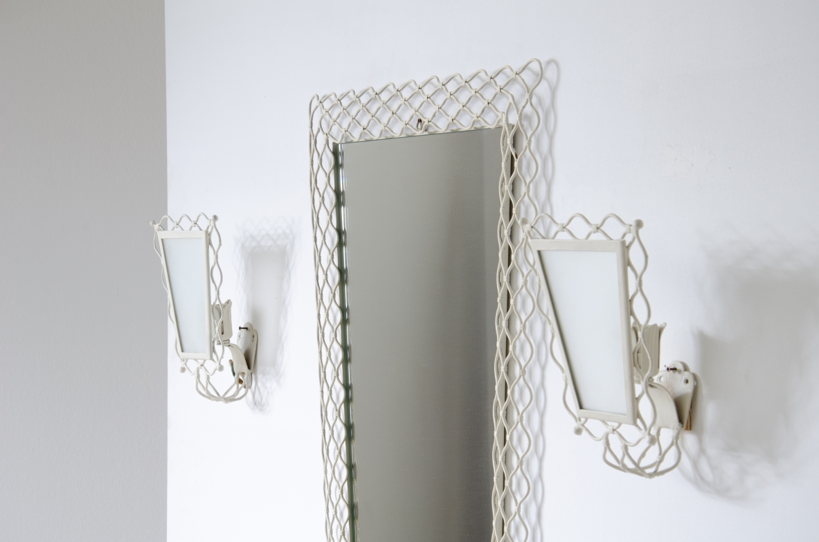 Mirror with curved metal mesh frame with two wall lights of the same workmanship with satin glass.  Italy 1950s.