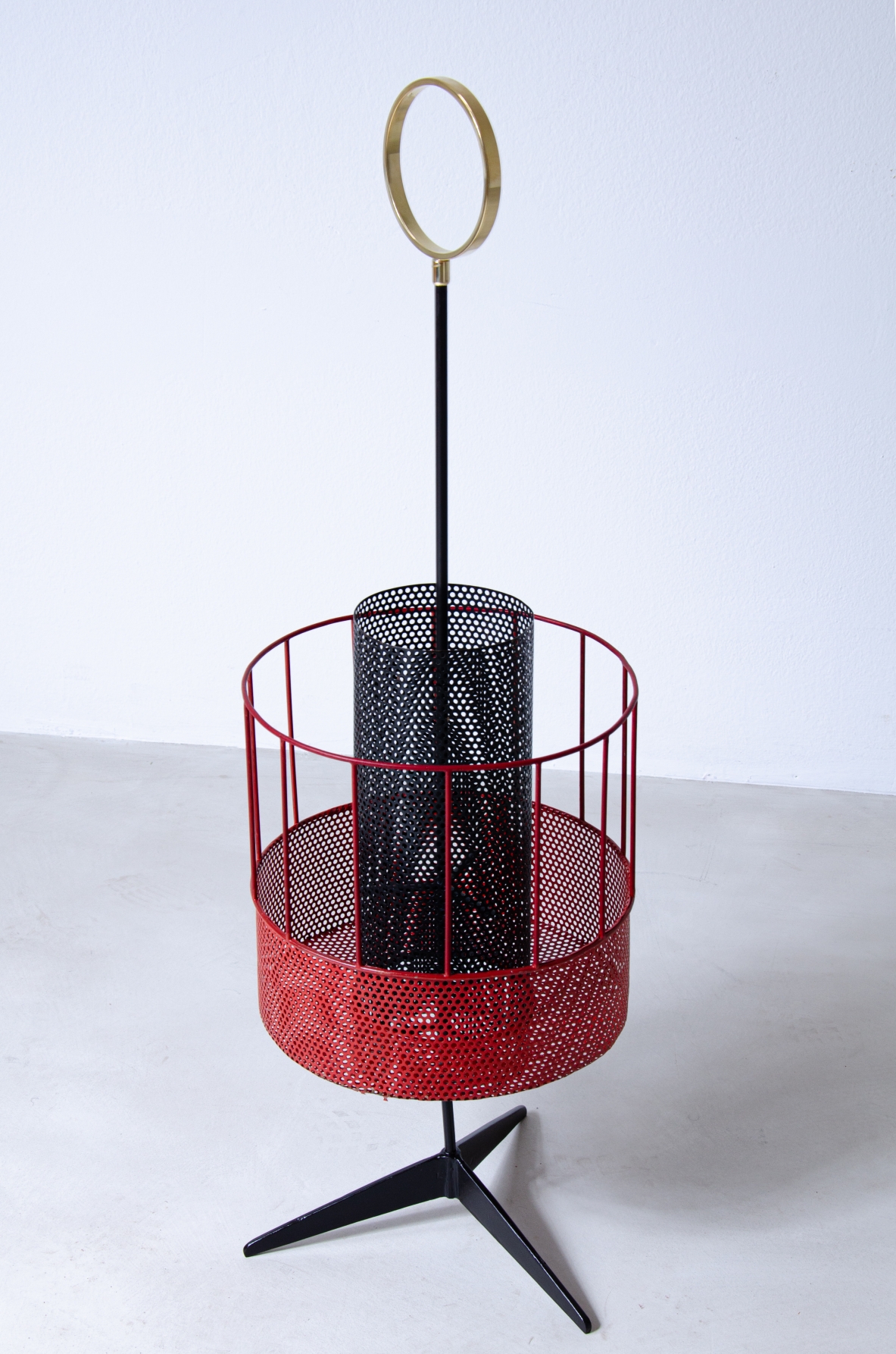 Mathieu Matègot, perforated and colored metal magazine rack or bottle holder with enamelled iron handle and foot.  French 1950s manufacture.