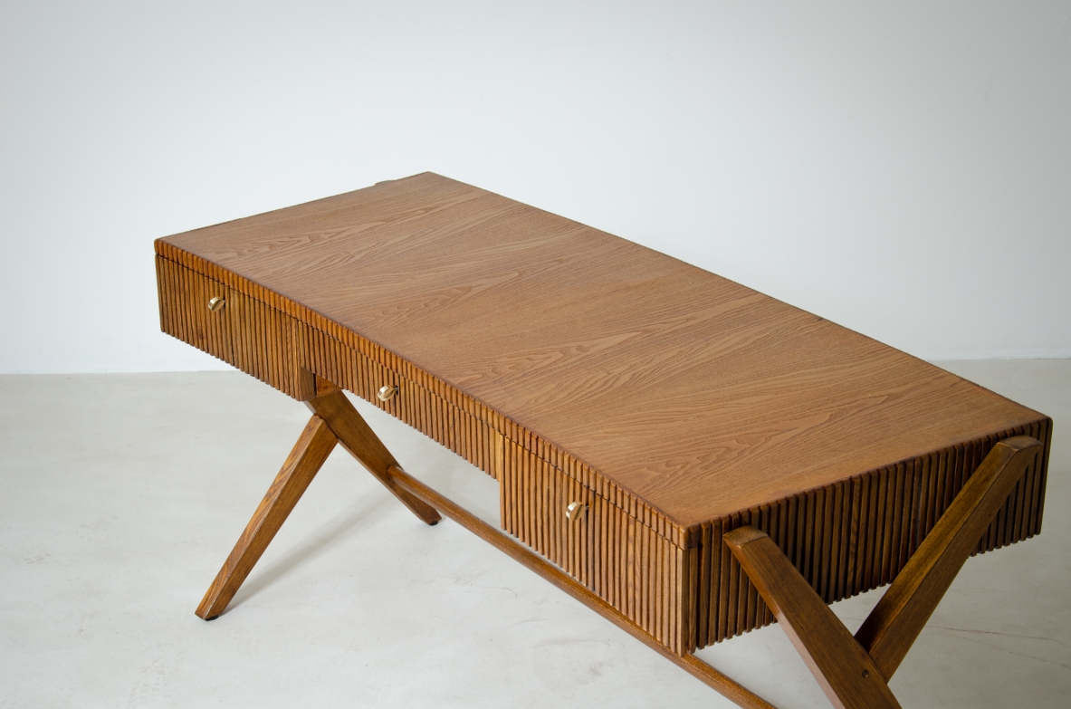 Oak desk with three drawers with ribbed wood band and curved top supported by double Y legs.  Turin School, Italy, 1950's.