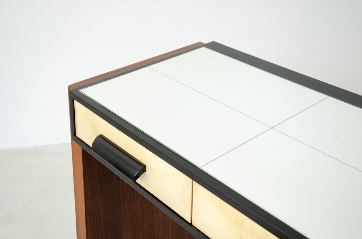 Splendid rosewood console table with three drawers covered in parchment and top in ground mirror.  Italian manufacture, 1930's.