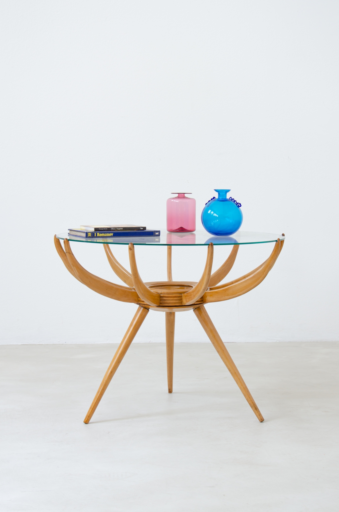 Carlo de Carli (1910-1999)  Coffee table in blond maple with three conical legs and nine curved arms that support a ground glass top.  1950's manufacture.
