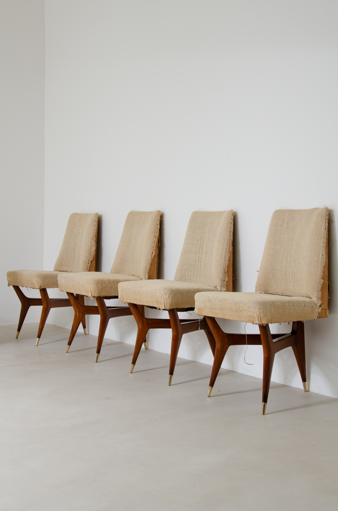 Melchiorre Bega (1898-1976)  Rare set of six wooden chairs with brass tips and fabric upholstery.  Italy, 1956