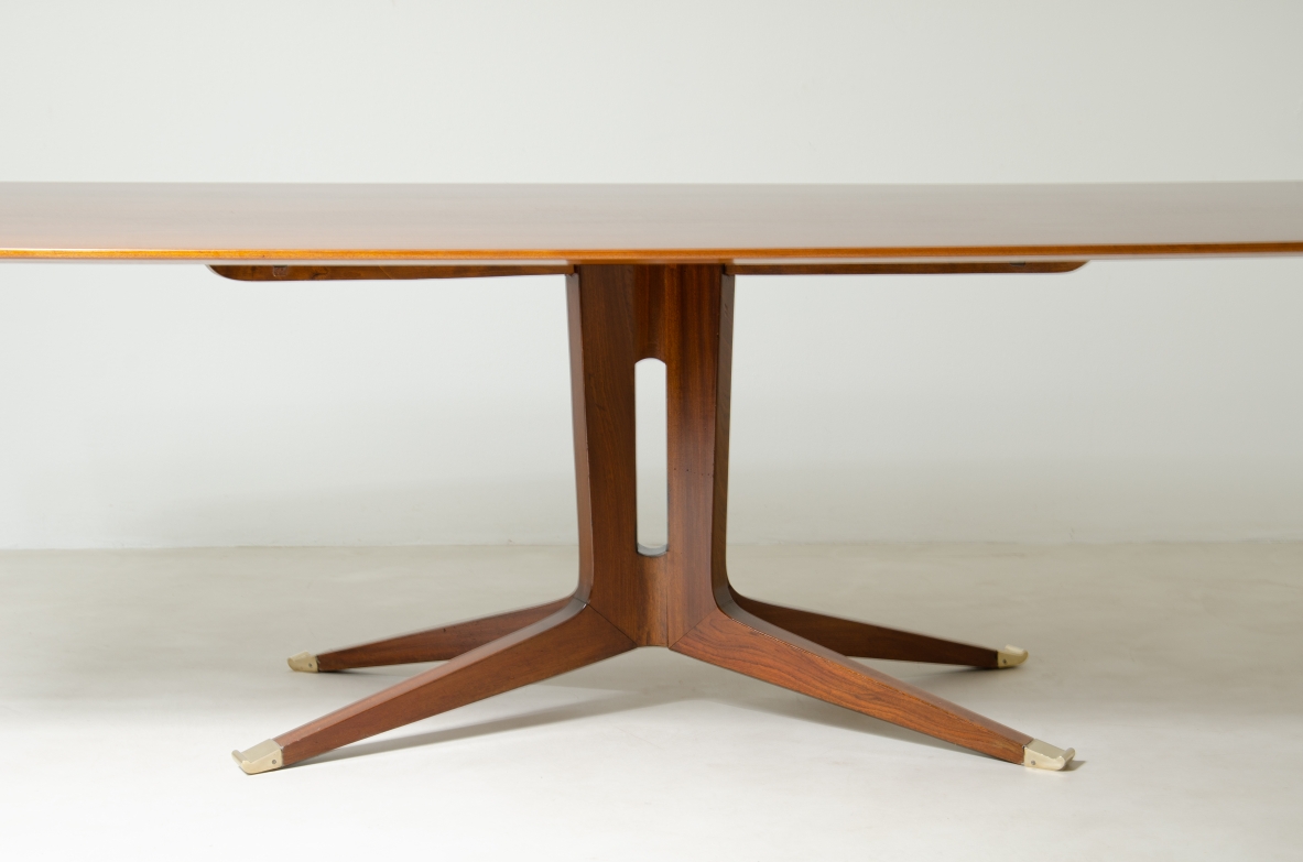 Large mahogany table with shaped top and leg with central stem and four spokes with elegant brass tip.  1950's Italian manufacture.