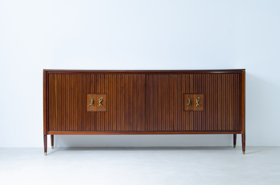 A large 1950's sideboard designed by Osvaldo Borsani for Arredamenti Borsani Varedo. Grinded mahogany, gilded bronze handles by Lucio Fontana, interior illumination.
