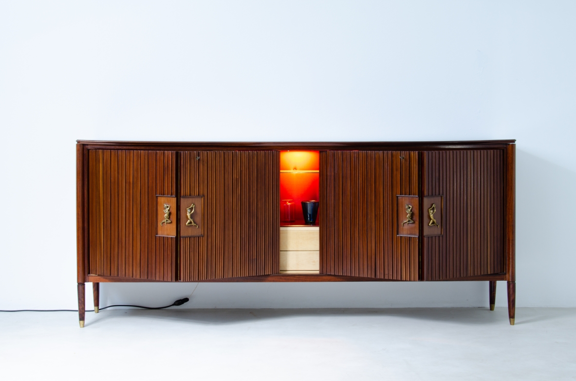 A large 1950's sideboard designed by Osvaldo Borsani for Arredamenti Borsani Varedo. Grinded mahogany, gilded bronze handles by Lucio Fontana, interior illumination.