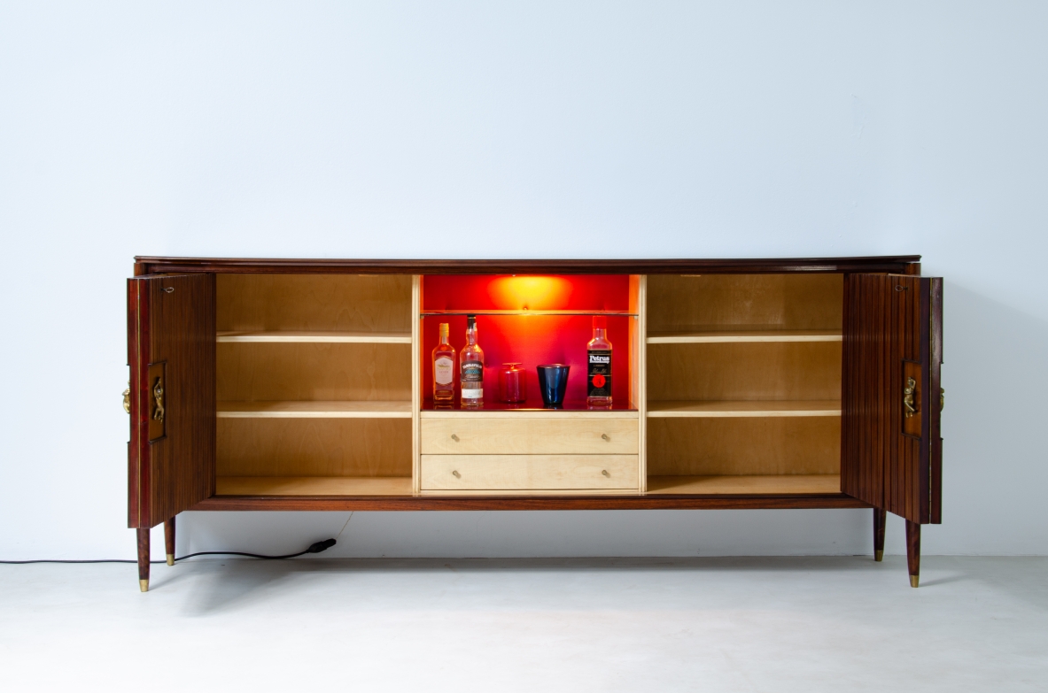 A large 1950's sideboard designed by Osvaldo Borsani for Arredamenti Borsani Varedo. Grinded mahogany, gilded bronze handles by Lucio Fontana, interior illumination.