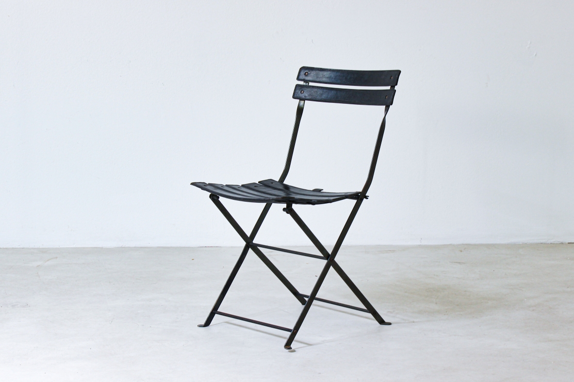 Folding chair in iron with upholstered in black leather. Italian manufacture, 1970's.