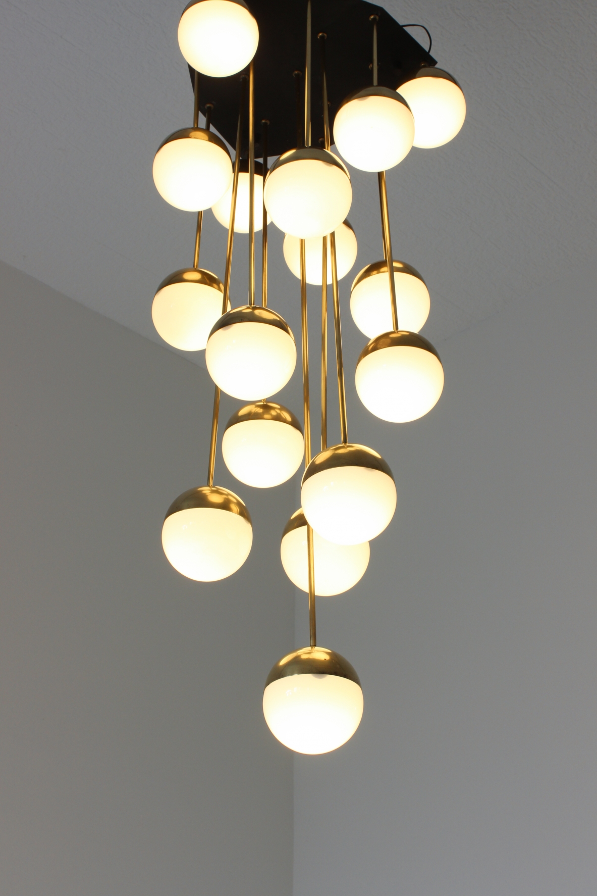 Large 18-light chandelier with brass structure and opaline glasses. Stilnovo production, 1960's.