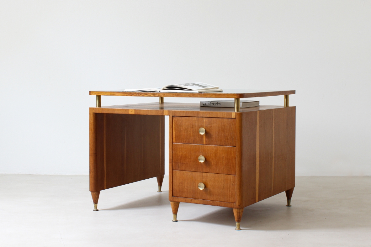 Writing table in oak wood with drawers on both sides, brass tips and crystal glass top.  Italian manufacture 1950's.