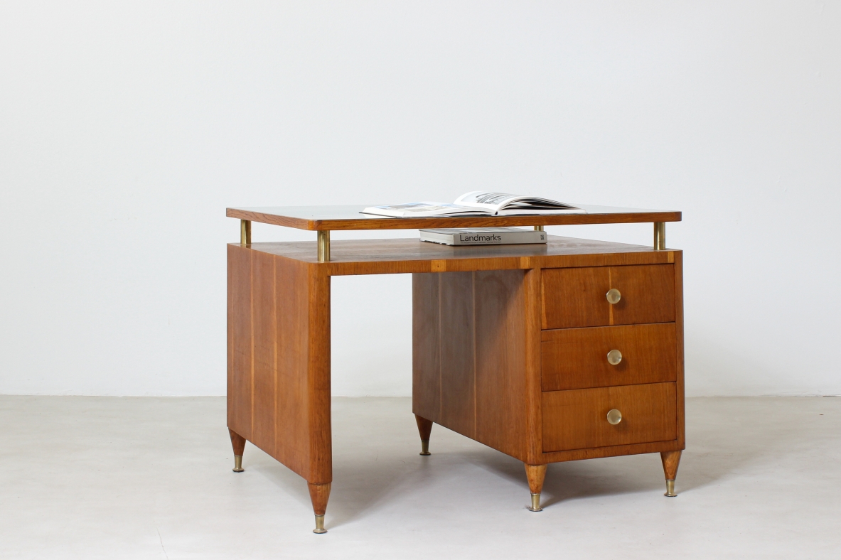 Writing table in oak wood with drawers on both sides, brass tips and crystal glass top.  Italian manufacture 1950's.