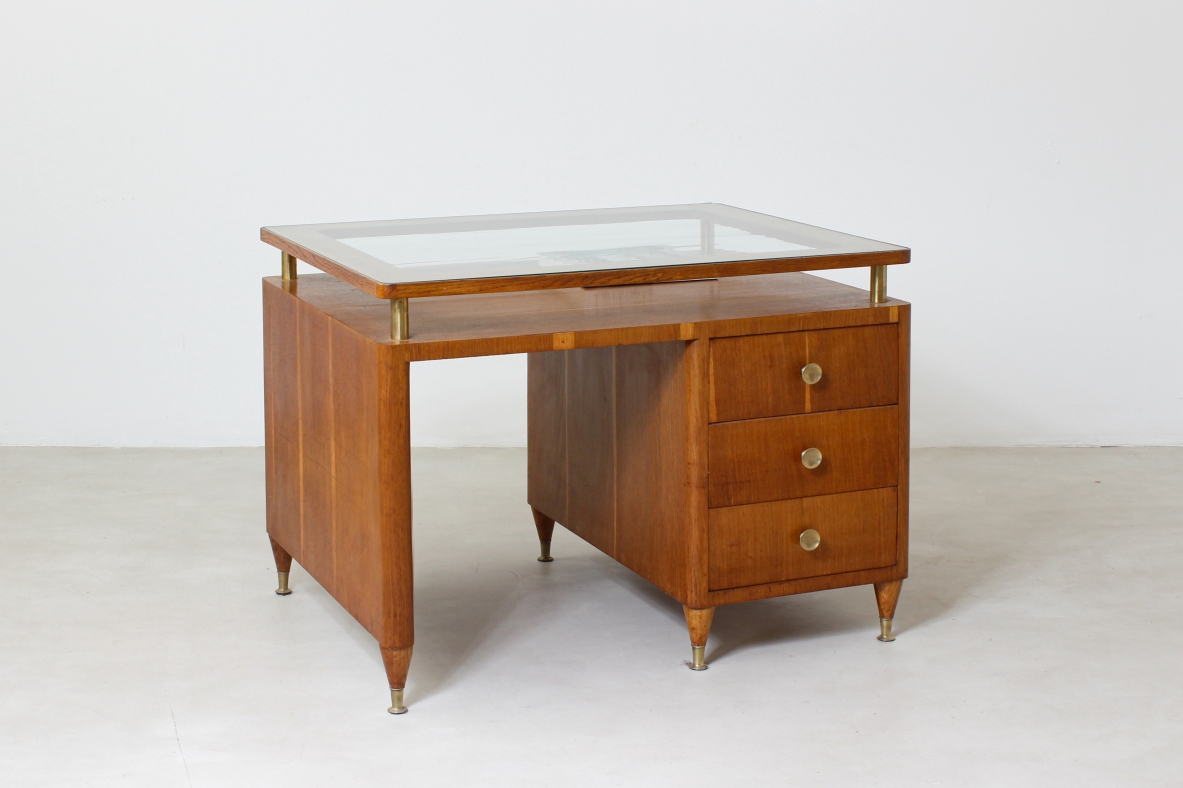 Writing table in oak wood with drawers on both sides, brass tips and crystal glass top.  Italian manufacture 1950's.
