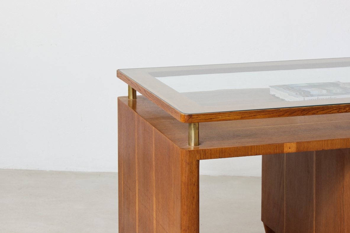Writing table in oak wood with drawers on both sides, brass tips and crystal glass top.  Italian manufacture 1950's.