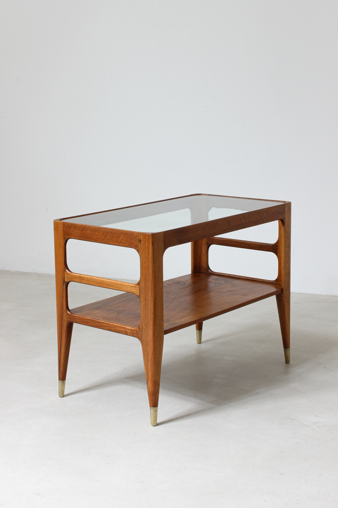 Unique pair of center tables in walnut with crystal glass top and sides openings, nice brass tips.  Attributed to Gio Ponti 1950's
