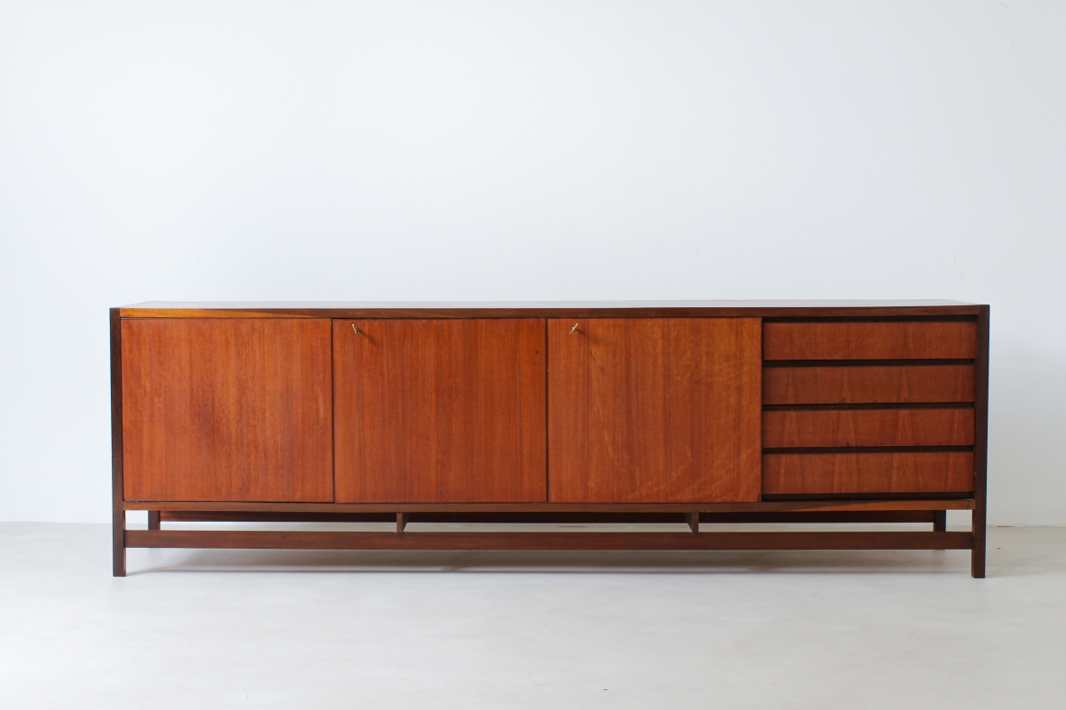 Sideboard in blond wood with three doors and drawers on one side.  Italian manufacture,1960s.