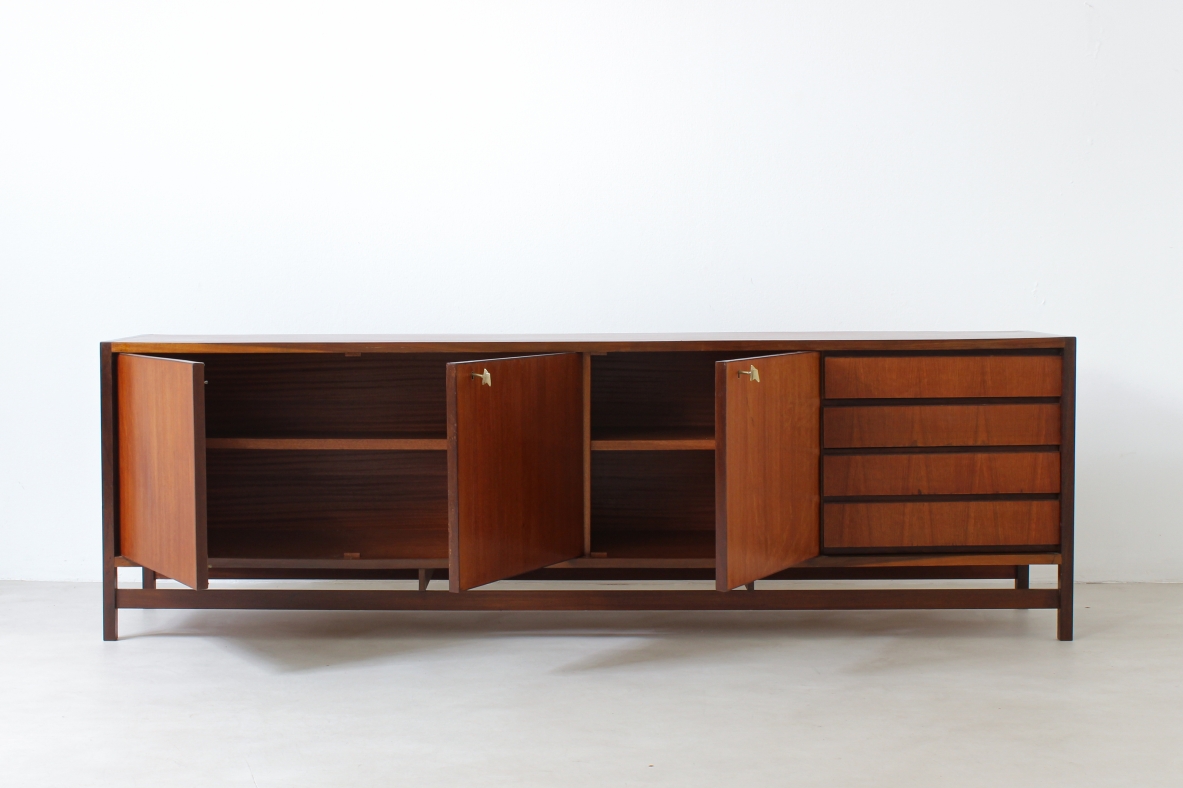 Sideboard in blond wood with three doors and drawers on one side.  Italian manufacture,1960s.