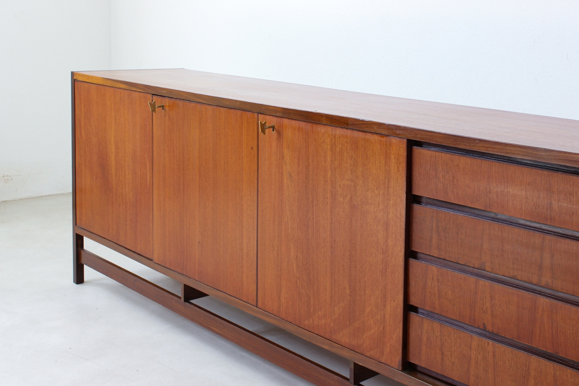Sideboard in blond wood with three doors and drawers on one side.  Italian manufacture,1960s.