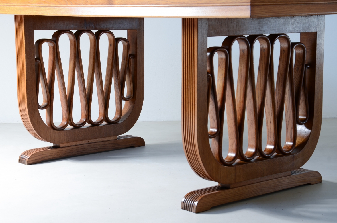 Extraordinary oak table with grissinate uprights and ribbon motif in the style of the period, top with shaped thickness.  Italian manifacture, 1940's