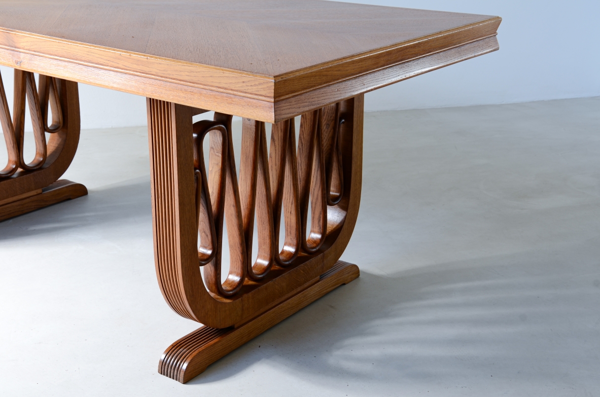 Extraordinary oak table with grissinate uprights and ribbon motif in the style of the period, top with shaped thickness.  Italian manifacture, 1940's