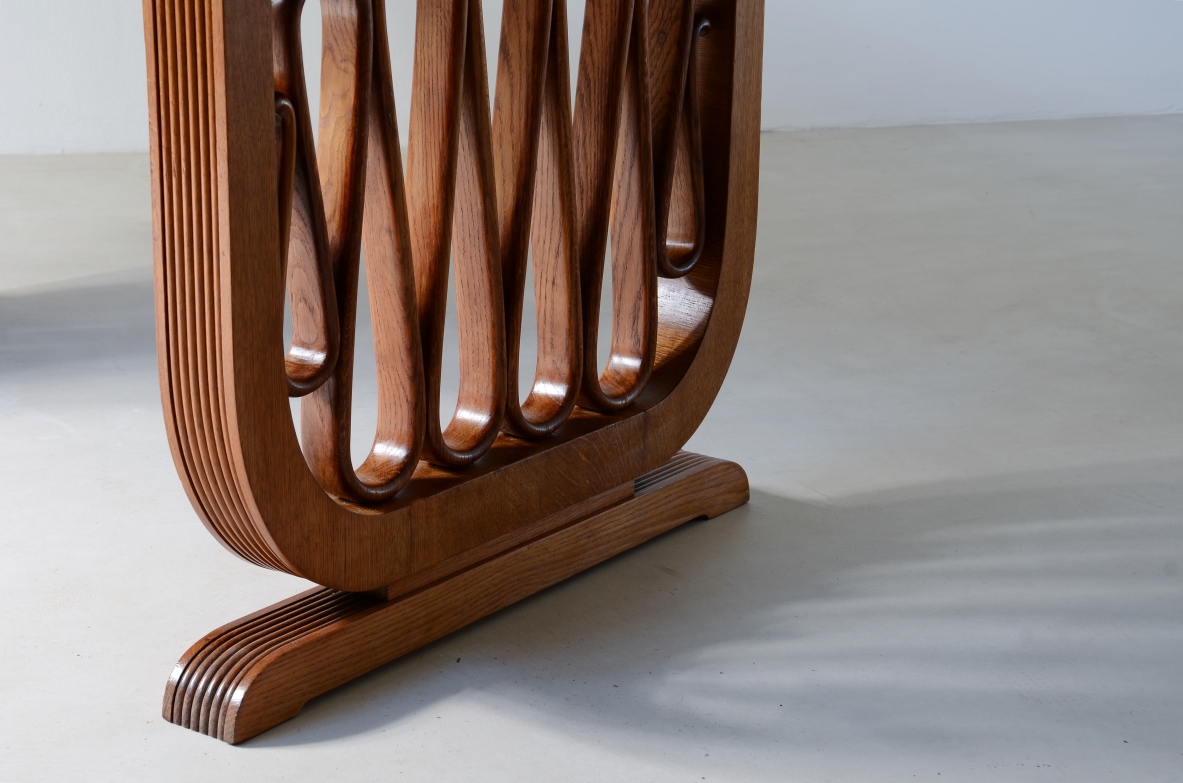 Extraordinary oak table with grissinate uprights and ribbon motif in the style of the period, top with shaped thickness.  Italian manifacture, 1940's