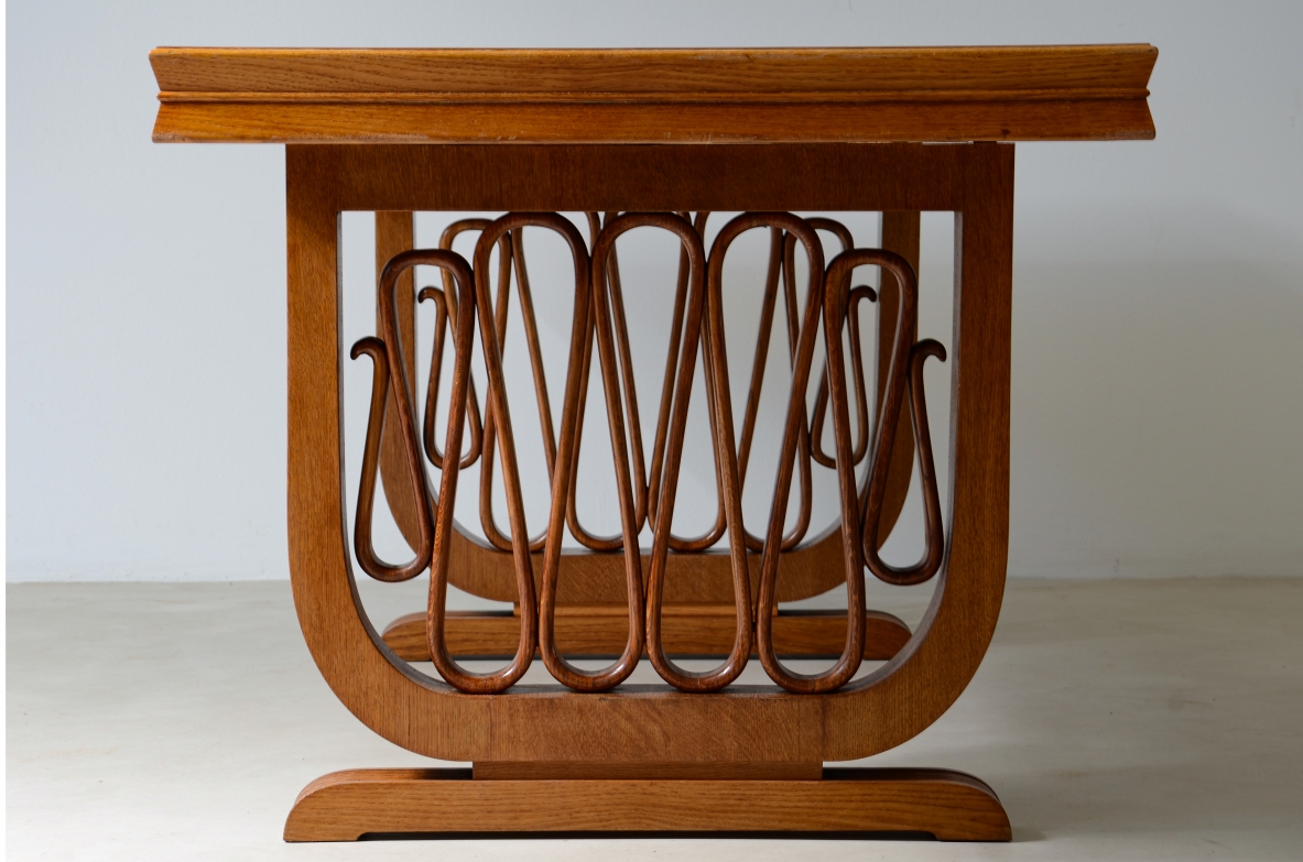 Extraordinary oak table with grissinate uprights and ribbon motif in the style of the period, top with shaped thickness.  Italian manifacture, 1940's