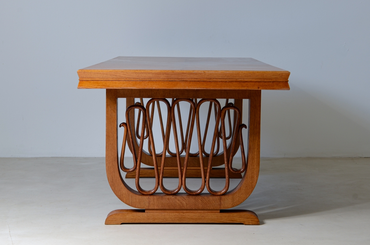 Extraordinary oak table with grissinate uprights and ribbon motif in the style of the period, top with shaped thickness.  Italian manifacture, 1940's