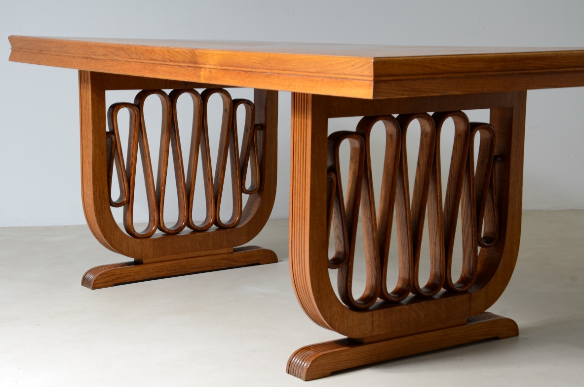 Extraordinary oak table with grissinate uprights and ribbon motif in the style of the period, top with shaped thickness.  Italian manifacture, 1940's
