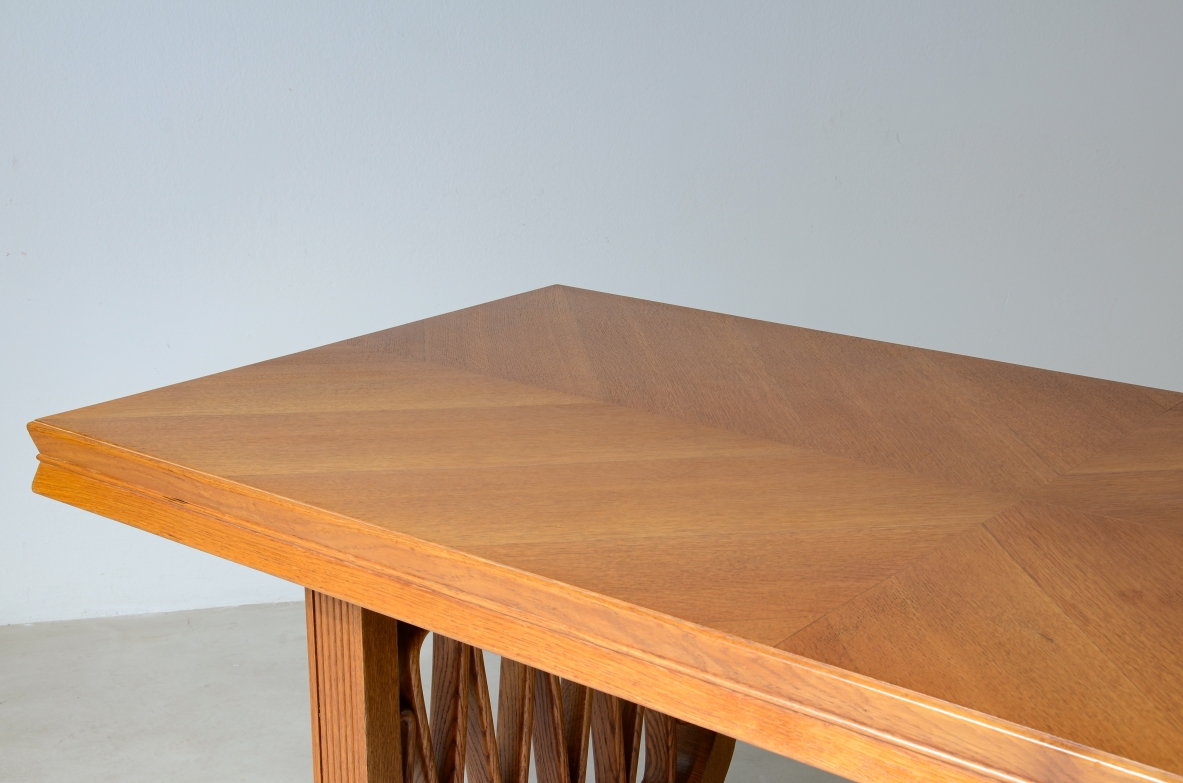 Extraordinary oak table with grissinate uprights and ribbon motif in the style of the period, top with shaped thickness.  Italian manifacture, 1940's