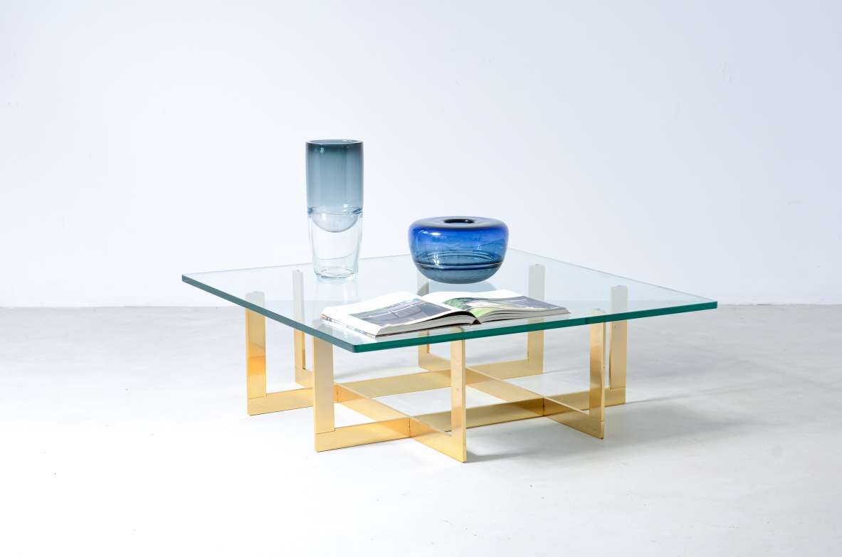 Elegant low table with brass structure and thick moulded crystal glass top.  Italian manufacture, around 1970.