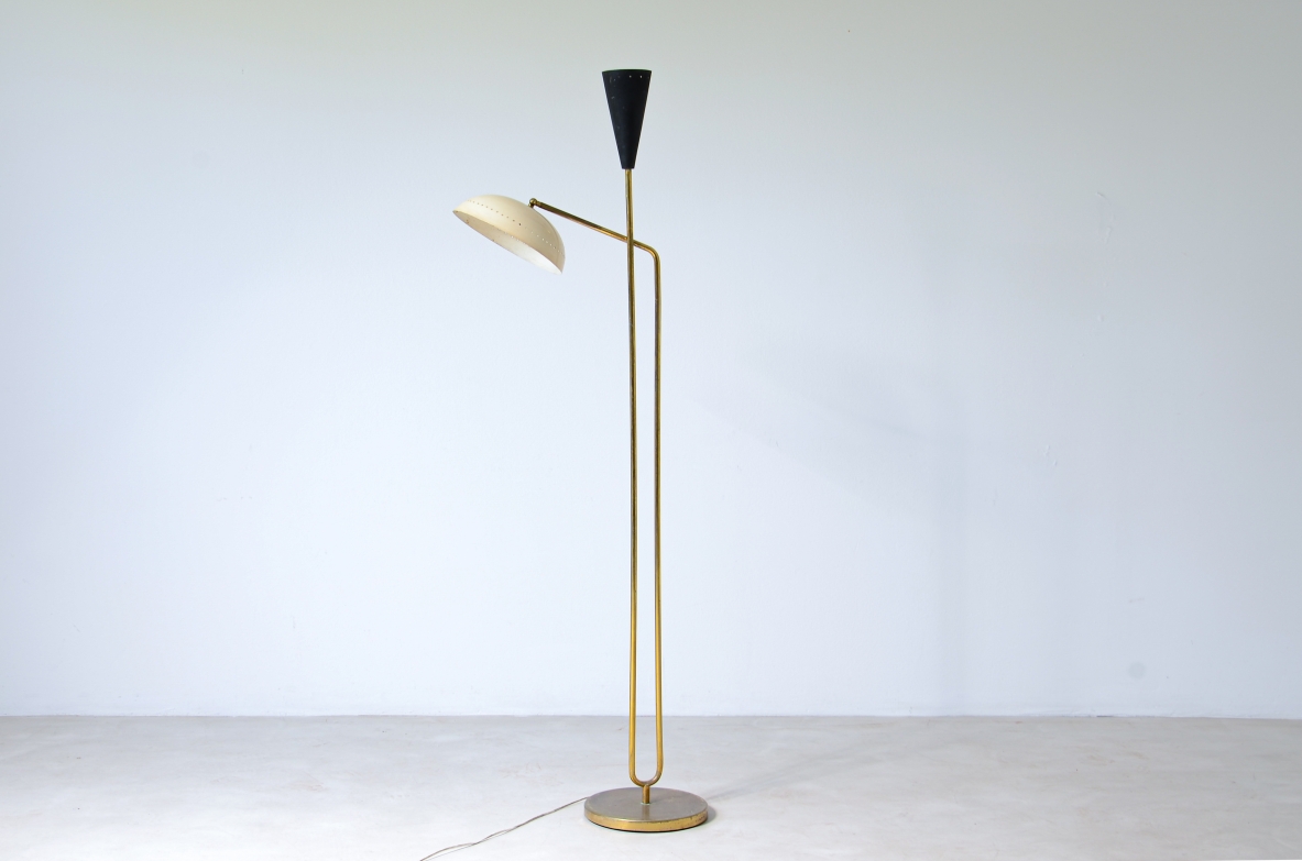 Two light brass floor lamp with cream colored metal shade and black lacquered cone.  Italian manufacture, around 1950.