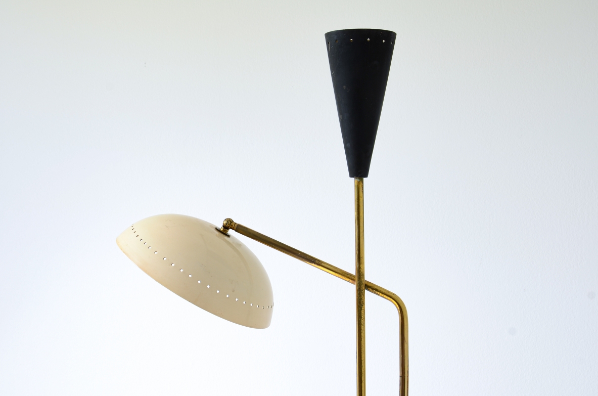 Two light brass floor lamp with cream colored metal shade and black lacquered cone.  Italian manufacture, around 1950.