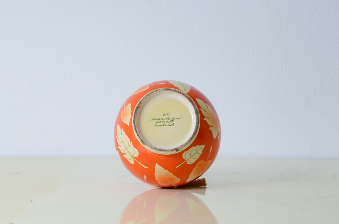 Rometti pottery  Round vase with leaves decoration on a coral colored background. Umbertide manufacture, 1930's.