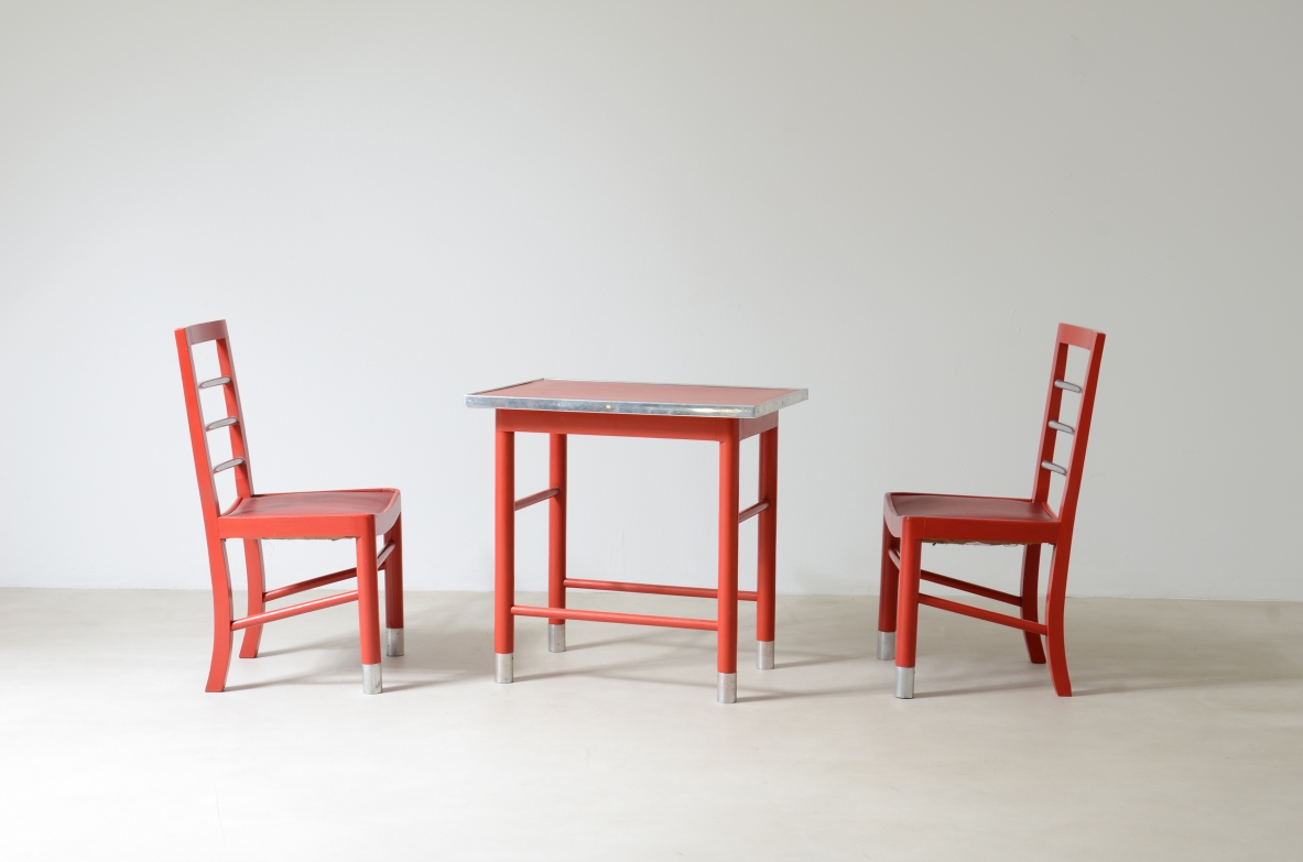 Marcello Piacentini (1881-1960)  Coffee table and two chairs in lacquered wood with satin metal details.  Excellent state of conservation.  Manufactured around 1930.