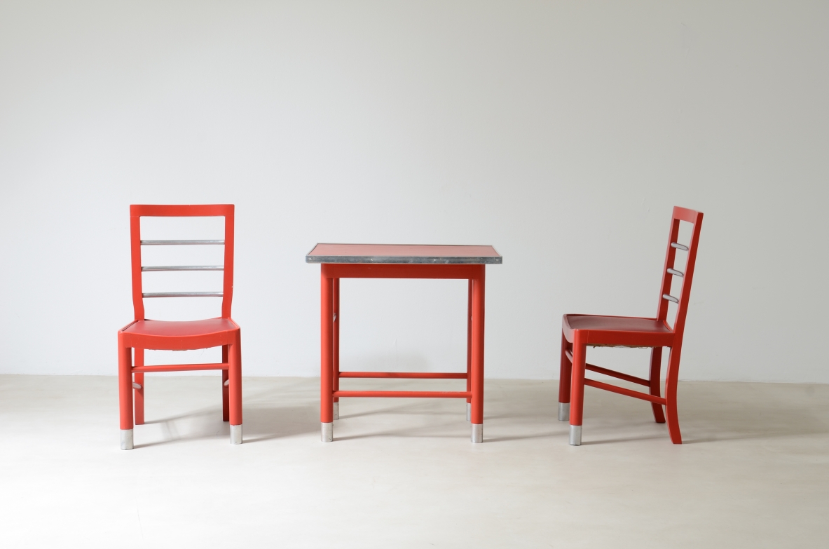 Marcello Piacentini (1881-1960)  Coffee table and two chairs in lacquered wood with satin metal details.  Excellent state of conservation.  Manufactured around 1930.