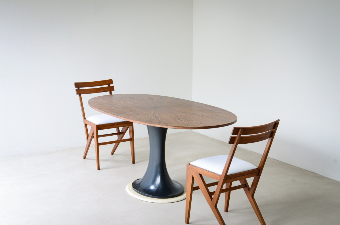 Elegant oval table with turned base in petrol blue lacquered wood and marble disc.  Palm wood veneer top.  Turin School, 1960's.