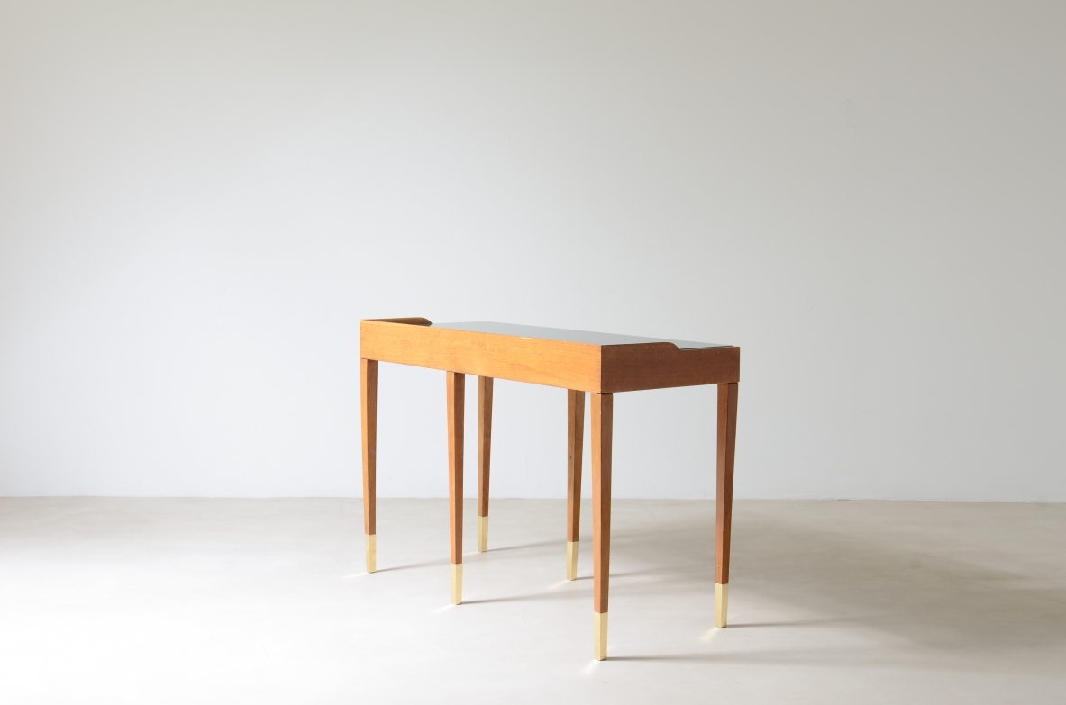 Refined oak writing desk with petrol green opaline glass top and backsplash.  Shaped drawer of the same color covered in polypropylene. Long thin legs with brass tips.  Attributed to Gio Ponti, early 1950s manufacture.